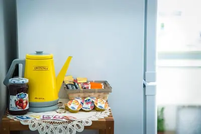 a table with a yellow juicer and a basket of food at Casa Alberone in Rome