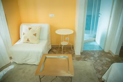 a living room with a white couch and a table at Casa Alberone in Rome