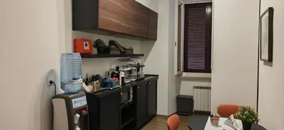 a kitchen with a black counter and a table at The B Place Cola in Rome