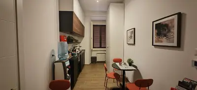 a kitchen with a table and chairs in a room at The B Place Cola in Rome