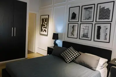 a bedroom with a bed and some pictures on the wall at The B Place Cola in Rome