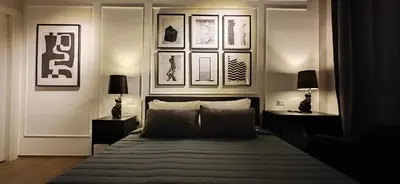 a bedroom with a bed and some pictures on the wall at The B Place Cola in Rome