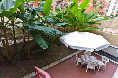 a patio with a white table and chairs and plants at A Casa di Pe' Casa Vacanze in Rome