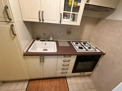 a small kitchen with a sink and a stove at SUITE 14 - Appartamento delizioso in ROMA Centro- 200 mt da METRO B in Rome