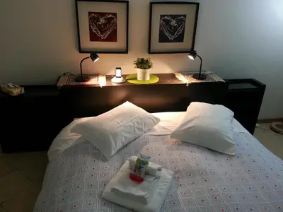 a bed with two pillows and a tray on it at SUITE 14 - Appartamento delizioso in ROMA Centro- 200 mt da METRO B in Rome