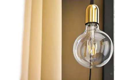 a glass light hanging from a wall next to a curtain at Bibi e Romeo's Home in Rome