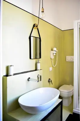 a bathroom with a white sink and a toilet at Bibi e Romeo's Home in Rome