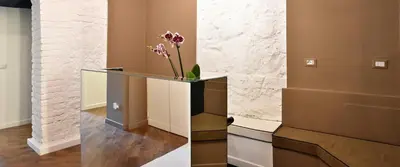 a console table with a vase of flowers in a room at Bibi e Romeo's Home in Rome