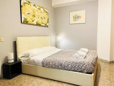 a bedroom with a bed with two towels on it at Piazza Meucci in Rome