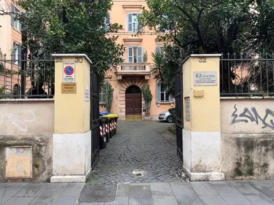 a gate to a building with a street at Napoleone Suite in Rome