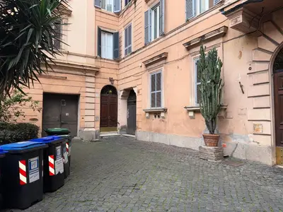 a building with two trash cans in front of it at Napoleone Suite in Rome