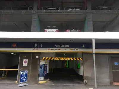 a parking garage with cars on top of it at Napoleone Suite in Rome