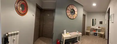 a room with a baby crib and a clock on the wall at Napoleone Suite in Rome