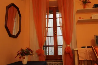 a room with a glass door with orange curtains at B&B A Casa Di Nancy in Rome