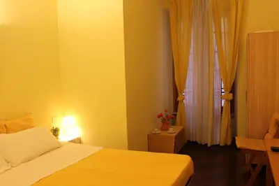 a bedroom with a bed and a yellow wall at B&B A Casa Di Nancy in Rome