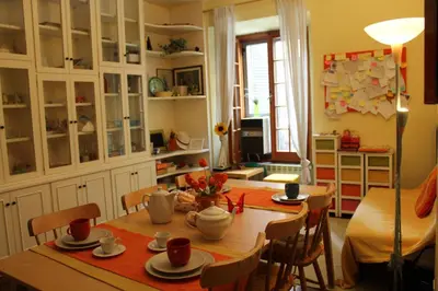 a dining room with a table and chairs in a room at B&B A Casa Di Nancy in Rome