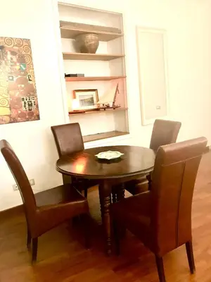a dining room with a wooden table and chairs at Le Sibille in Rome