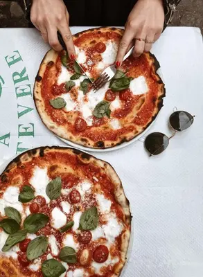 two pizzas sitting on top of a table at Le Sibille in Rome