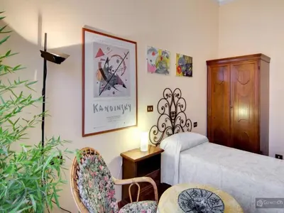 a bedroom with a bed and a table and chairs at Oltre le Mura in Rome