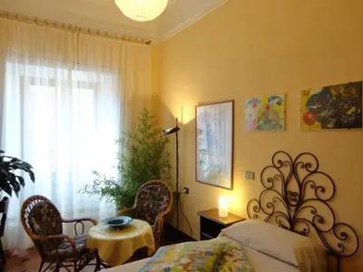 a bedroom with a bed and a table and a window at Oltre le Mura in Rome