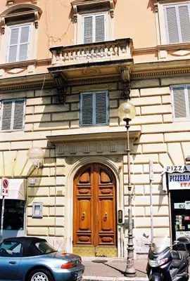a building with a wooden door on a city street at Oltre le Mura in Rome