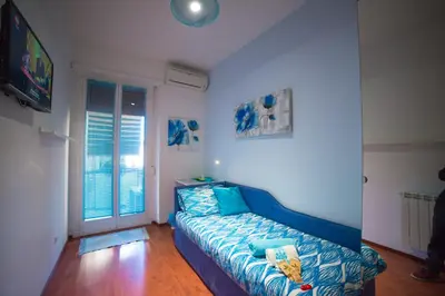 a living room with a blue couch and a television at Green Line in Rome