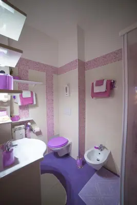 a purple bathroom with a toilet and a sink at Green Line in Rome