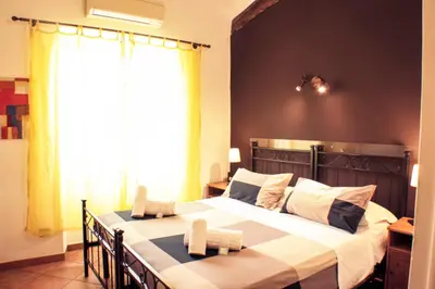 a bedroom with a large bed with two towels at Sixtythree guesthouse in Rome