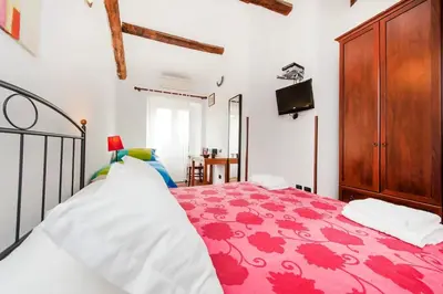 a bedroom with a bed with a red bedspread at Sixtythree guesthouse in Rome
