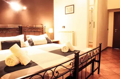 a bedroom with a large bed with towels on it at Sixtythree guesthouse in Rome