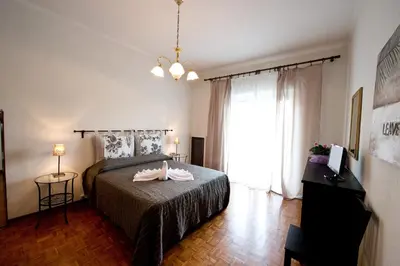 a bedroom with a bed and a large window at ACasaDiEnza in Rome
