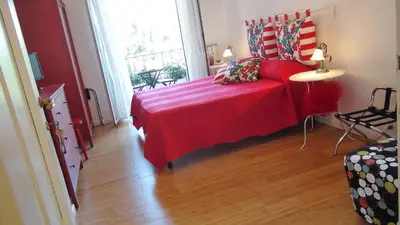 a bedroom with a red bed and a window at ACasaDiEnza in Rome