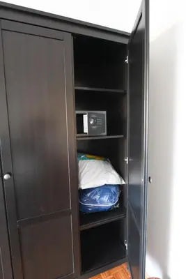 a black cabinet with a microwave in it at ACasaDiEnza in Rome