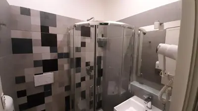 a bathroom with a shower with a toilet and a sink at Youth Station Hostel in Rome