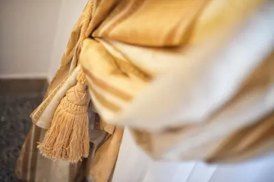 a person wearing a tan scarf with a tassel at B&B Le Sibille in Rome