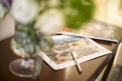 a table with a vase and a book and a vase at B&B Le Sibille in Rome