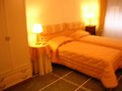 a hotel room with two beds and a lamp at B&B Le Sibille in Rome