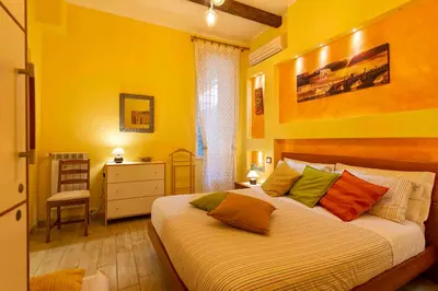 a bedroom with a large bed with colorful pillows at Domus Clodio in Rome