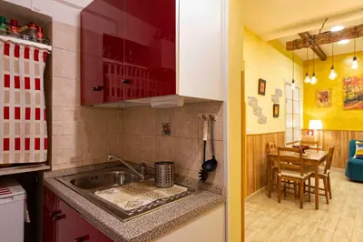 a small kitchen with a sink and a table at Domus Clodio in Rome