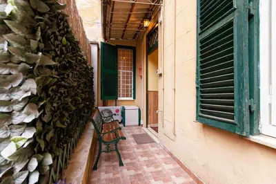 a bench sitting on a porch next to a building at Domus Clodio in Rome