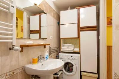 a bathroom with a sink and a washing machine at Domus Clodio in Rome