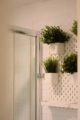 a bathroom with two potted plants on a wall at Trust-Trastevere in Rome