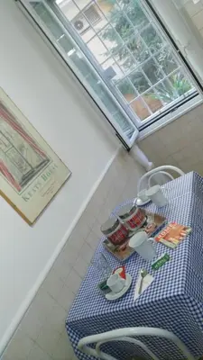 a blue table with plates and utensils on it at Trionfal Apartment in Rome