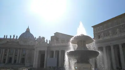 a water fountain in front of a large building at Trionfal Apartment in Rome