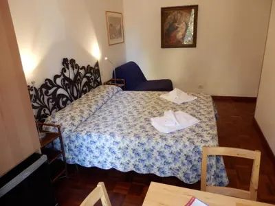 a small room with a bed with shoes on it at At Rome St. Peter's in Rome