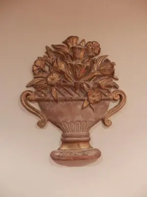a vase with a flower design on a wall at At Rome St. Peter's in Rome