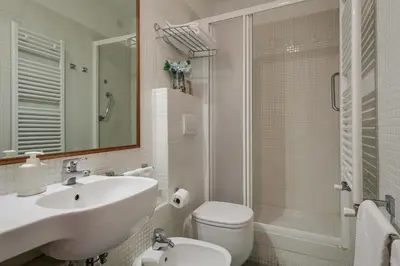 a bathroom with a sink and a toilet and a shower at At Rome St. Peter's in Rome
