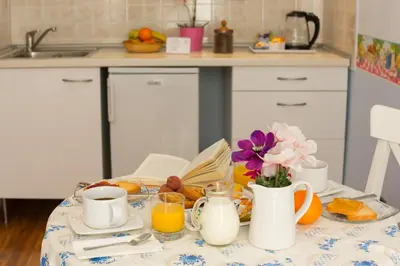 a breakfast table with a plate of breakfast foods and drinks at Malkavacanze B&B in Rome