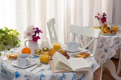 a table with breakfast foods and a book on it at Malkavacanze B&B in Rome