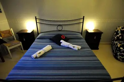 a bed with two pillows on top of it at La Casa Romana in Rome